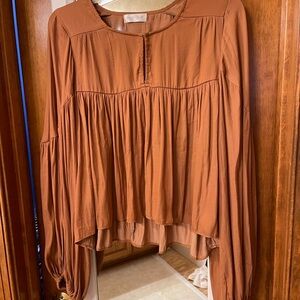Vestique flowing long sleeved top